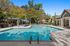 Luxurious outdoor swimming pool area with stylish seating and lush greenery, perfect for relaxation and leisure.