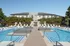 Luxurious resort-style swimming pool area with modern lounge chairs and sleek architecture, perfect for relaxation and leisure.