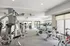 Spacious modern gym with state-of-the-art fitness equipment, featuring cardio machines and strength training facilities.