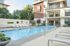 Inviting apartment complex with a pristine pool area, surrounded by stylish loungers and lush greenery at Legacy North.
