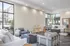 Spacious and elegant living room with modern furniture, large windows, and abundant natural light.