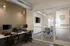 Modern business center with sleek workstations, glass-walled conference room, and sophisticated decor for a professional setting.