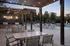 Chic outdoor patio with string lights, modern seating, and poolside loungers creating a perfect relaxation spot.