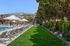 Luxurious apartment community pool area with modern lounge chairs, umbrellas, and lush greenery for a serene escape.