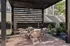 Inviting outdoor patio with elegant wicker furniture beneath a modern pergola, perfect for relaxation.