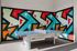 Vibrant recreation area featuring a modern ping pong table against a bold, colorful geometric mural.