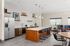 Modern kitchen with sleek island, elegant bar stools, and contemporary decor, perfect for entertaining.
