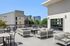 Chic outdoor patio with modern seating and vibrant city view, perfect for relaxation.