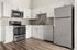 Modern kitchen featuring sleek stainless steel appliances, elegant white cabinetry, and stylish tile backsplash, perfect for culinary enthusiasts.