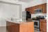 Modern kitchen with sleek stainless steel appliances, elegant granite countertops, and warm wooden cabinets for a stylish culinary space.