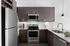 Elegant modern kitchen with dark wood cabinetry, stainless steel appliances, and sleek granite countertops.