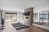Bright and modern fitness studio with large mirrors, yoga mats, and weights, perfect for a healthy lifestyle.