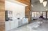 Elegant lobby area featuring modern seating, stylish lighting, and a sleek beverage station, creating a welcoming atmosphere.