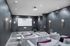 Luxurious modern theater room with plush seating, ambient lighting, and a large projection screen.