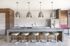 Modern kitchen design featuring sleek countertops, stylish pendant lighting, and elegant barstools, offering a sophisticated space for entertaining.