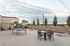 Chic urban rooftop terrace with string lights, outdoor table set, and leisure games, perfect for entertaining.