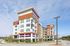 Modern apartment complex with stylish architecture, featuring spacious balconies and lush landscaping, now open for leasing.