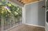 Inviting balcony space with wooden decking and scenic forest views, perfect for relaxation and outdoor enjoyment.