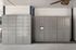 Modern parcel locker system in an elegant apartment lobby, featuring sleek cabinetry and a built-in digital screen.