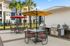 Inviting outdoor patio with vibrant umbrellas, stylish seating, and modern grills, ideal for social gatherings.