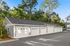 Charming row of garages nestled amidst lush greenery, providing secure and convenient parking solutions.