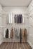 Spacious walk-in closet showcasing sleek wooden flooring and organized wire shelving for optimal storage.