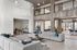 Spacious modern living area with elegant design, featuring plush gray seating, stylish lighting, and an inviting open layout.