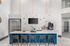 Modern apartment kitchen with sleek countertops, luxurious pendant lighting, and stylish bar stools.