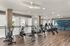 Modern fitness studio with state-of-the-art exercise equipment, elegant wood flooring, and stylish interior design.