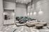 Modern and inviting community theater room with stylish seating, plush cushions, and a cozy home theater vibe.