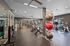 Modern fitness center with sleek equipment and vibrant exercise balls under ambient lighting.