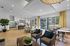 Modern open-concept living area with stylish seating, sleek kitchen, and floor-to-ceiling windows for natural light.