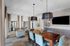 Elegant dining area with modern decor, plush seating, and natural light from large windows, perfect for social gatherings.