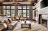Inviting living room with elegant wooden beams, plush seating, and a grand fireplace, offering a scenic view through expansive windows.