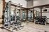 Modern gym with premium fitness equipment, mirrored walls, and sleek flooring, offering a luxurious workout experience.