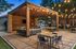 Charming outdoor patio with string lights, cozy seating area, and stylish wooden pergola perfect for entertaining.