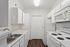 Bright, modern kitchen with sleek white cabinets, ample counter space, and contemporary appliances.
