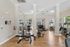 Bright and modern fitness center with high-quality equipment and large windows, offering a vibrant workout environment.