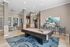 Chic recreational room featuring a modern pool table, trendy seating, and vibrant artwork, perfect for entertainment and relaxation.