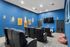 Luxurious home theater with plush leather seating, vibrant blue walls, and a large flat-screen TV for an ultimate cinematic experience.