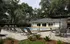 Inviting outdoor pool area surrounded by lush greenery and comfortable lounge chairs, offering a perfect spot for relaxation.