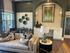 Chic living area with stylish decor, elegant seating, and natural light from large windows.