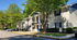 Inviting two-story apartment building with charming balconies and lush landscaping, offering a serene living environment.