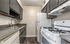 Charming modern kitchen with sleek grey cabinetry, spacious countertops, and essential appliances.