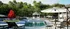 Luxurious outdoor pool area with elegant sun loungers, a charming gazebo, and lush greenery creating a serene retreat.
