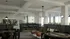 Elegant communal space featuring stylish poker tables, chic modern lighting, lush green decor, and cozy seating areas perfect for relaxation and entertainment.