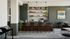 Modern communal coffee bar with sleek bar stools, stylish shelving, and contemporary decor.