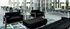 Chic community lounge featuring modern black seating, vibrant green accents, and a ping-pong table for leisure and social gatherings.