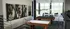Chic recreational room with modern art decor, featuring a stylish air hockey table and pool table, overlooking a scenic view through large glass windows.