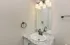 Elegant bathroom featuring a modern granite countertop, sleek sink, and stylish lighting fixtures.